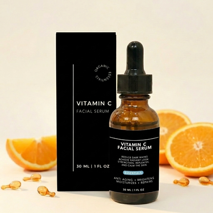 Vitamin C facial serum bottle with packaging and oranges on a light background